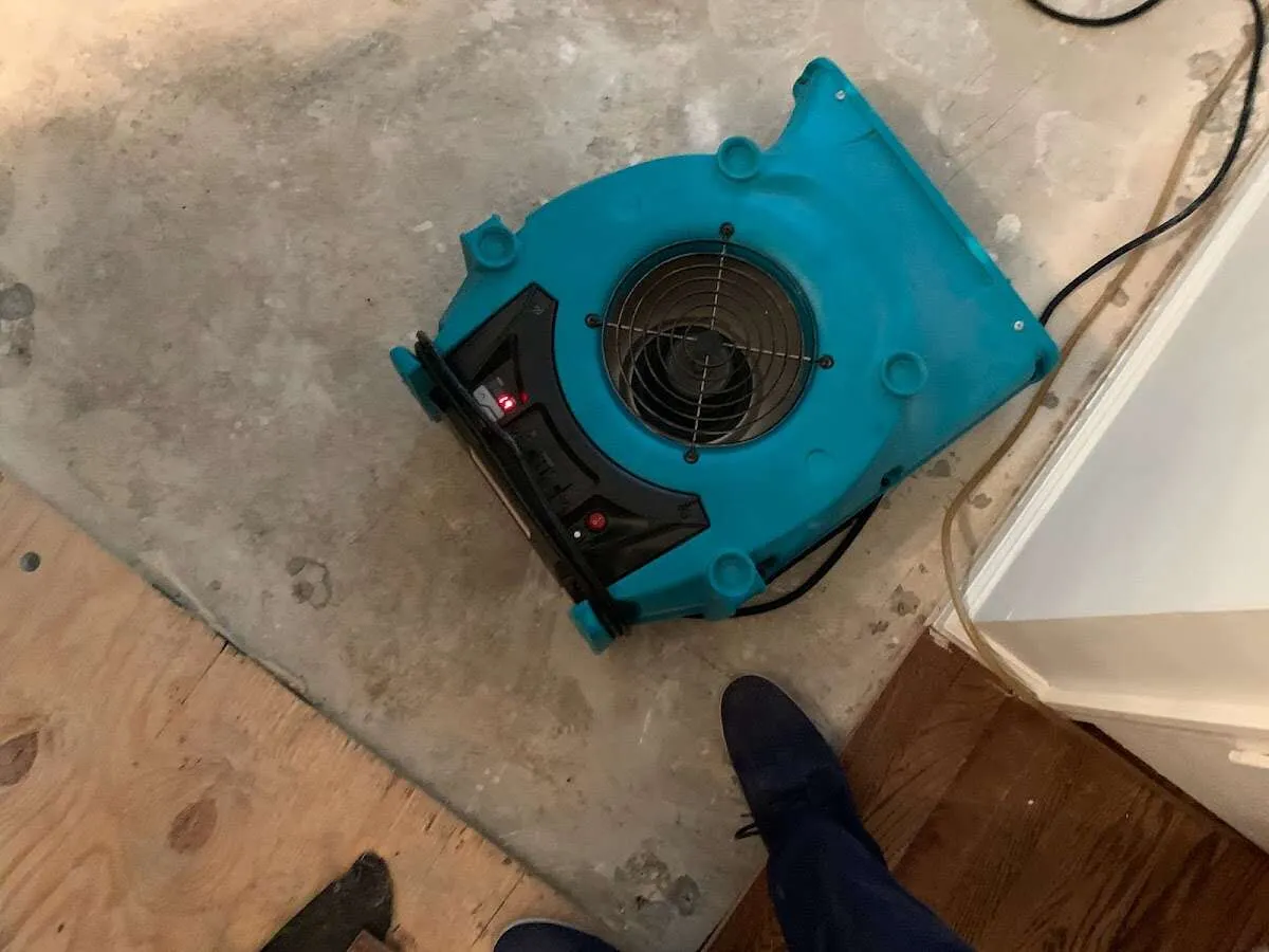 Air mover drying subfloor during Commercial Water Damage Restoration in North Providence